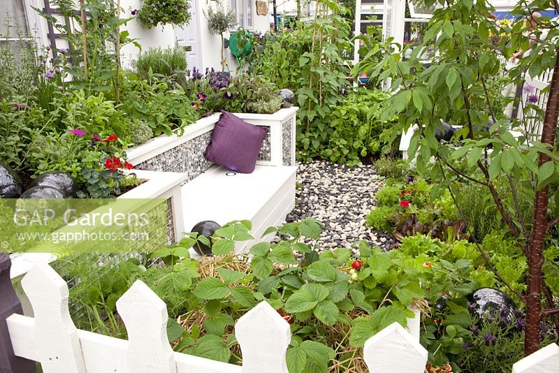 Wooden seating in vegetable garden. RHS Chelsea Flower Show 2010
 