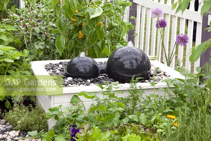 Raised water feature in vegetable garden. RHS Chelsea Flower Show 2010
 
