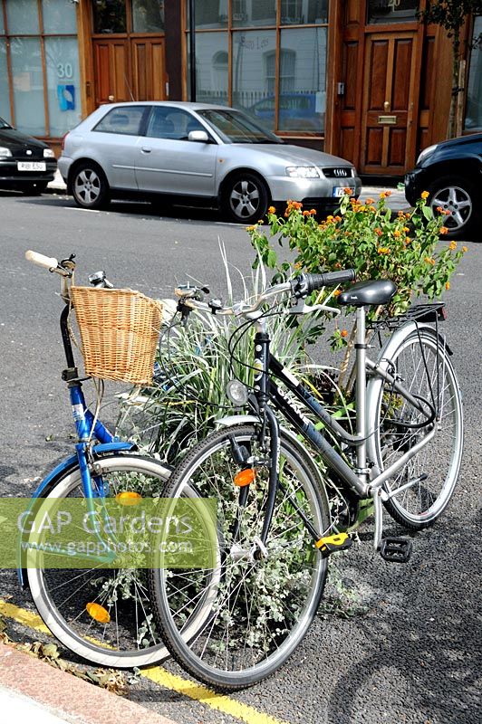 On road cycle parking in an Islington street using Plantlock containers filled with plants, North London. 