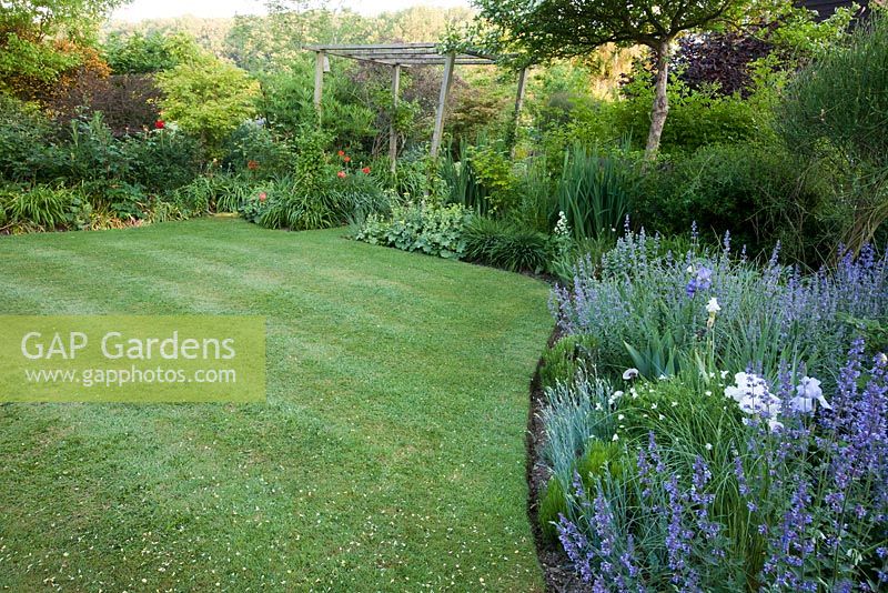 Landscaped raised lawn with early summer border - Old Buckhurst, Kent
