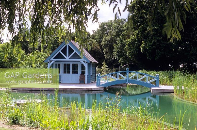 Natural swimming pool which is rain water fed, water lilies, reed filter beds, decking, bridge and gazebo 