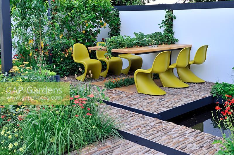 Outdoor dining table planted with Strawberries in the centre with lemon tree along wall. 'Food 4 Thought' - Gold Medal Winner - RHS Hampton Court Flower Show 2010 
 