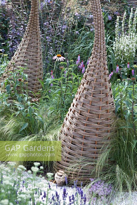 Willow sculptures in borders. 'It's Only Natural' - Silver Gilt Medal Winner - RHS Hampton Court Flower Show 2010 