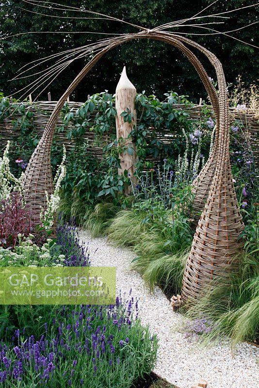 Interwoven willow structures and shell path in wildlife garden. 'It's Only Natural' - Silver Gilt Medal Winner - RHS Hampton Court Flower Show 2010 
 