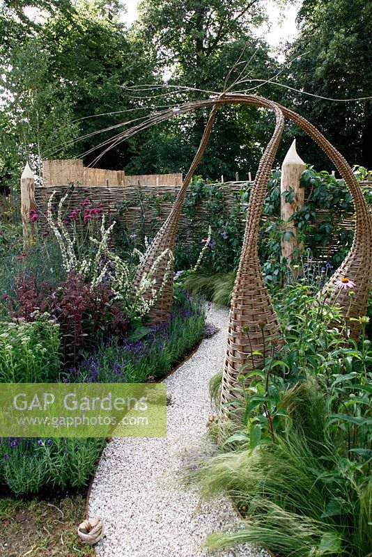 Interwoven willow structures and shell path in wildlife garden. 'It's Only Natural' - Silver Gilt Medal Winner - RHS Hampton Court Flower Show 2010 
 