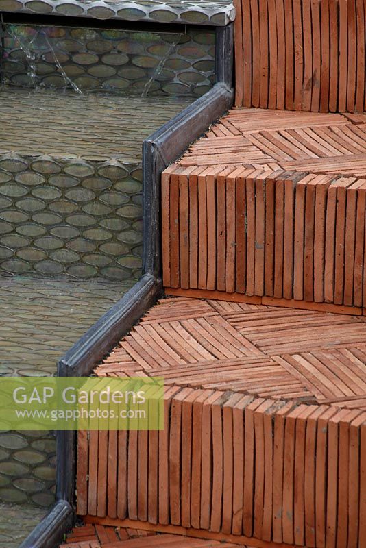Herringbone terracotta tiled steps and water feature. 'The Garden Lounge' - Silver Gilt Medal Winner - RHS Hampton Court Flower Show 2010  