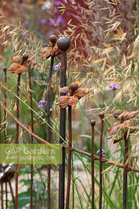 Decorative metal railings forming the boundary of 'The Fire Pit Garden' - Silver Medal Winner at the RHS Hampton Court Flower Show 2010