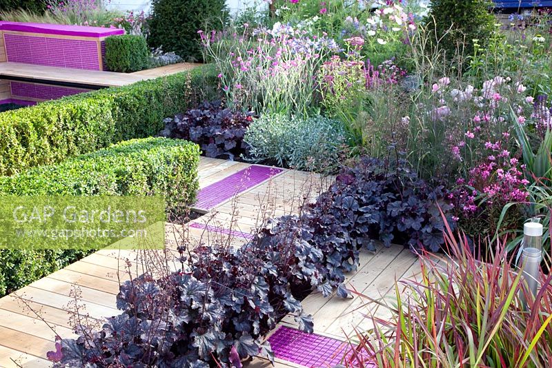 Decked paths with pink tiles, planting of Heuchera 'Obsidian' and Imperata cylindrica 'Red Baron' - 'A Matter of Urgency', Silver Gilt medal winner - RHS Hampton Court Flower Show 2010 
 
