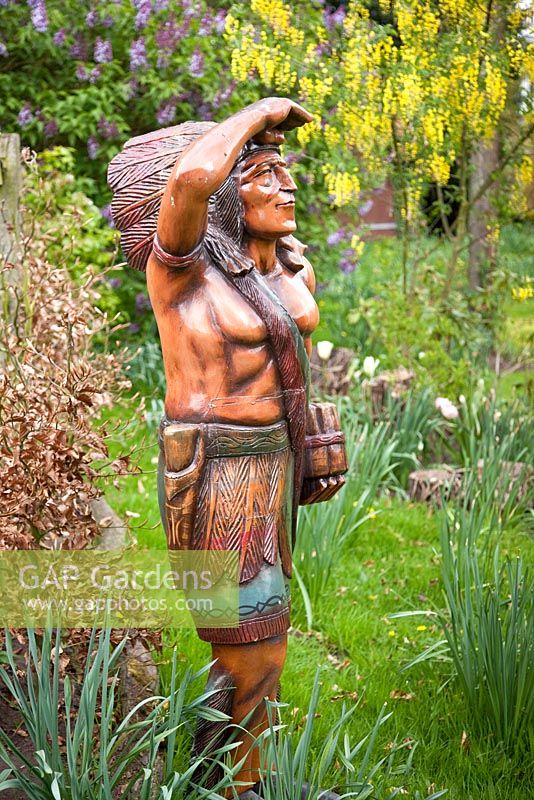 Wooden statue of Red Indian at Millenium Garden (NGS) Lichfield, UK, May
 