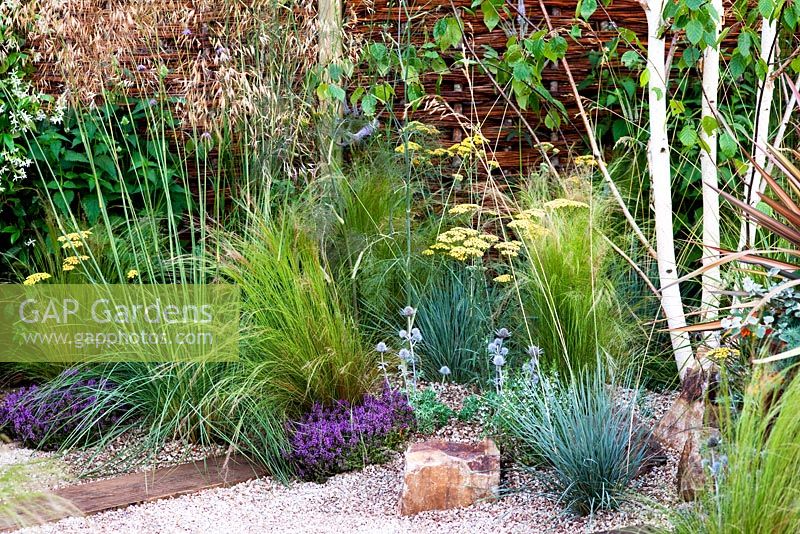 Gravel path with railway sleepers and Stipa tenuissima in The Fire Pit Garden - RHS Hampton Court 2010