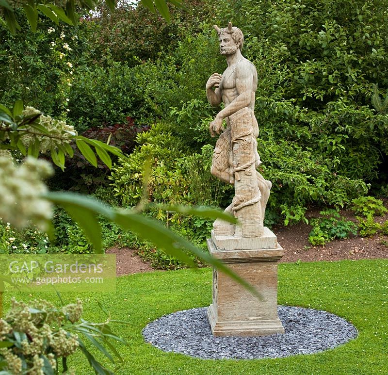 Large stone statue of Brutus - Wilkins Pleck NGS, Whitmore, Staffordshire, UK. July 
 