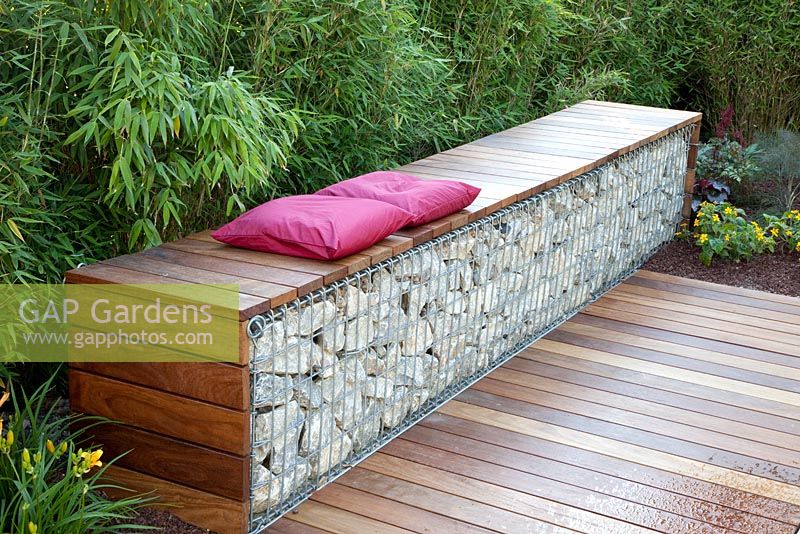 Bench made from wood and gabions backed by Fargesia murielae - Bamboo hedge