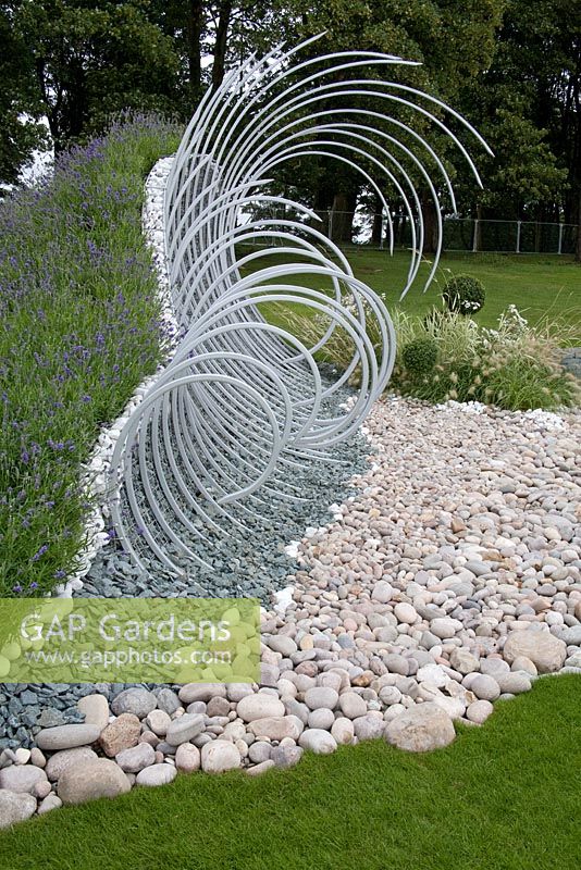 'Wave Dance' pebble beach garden with steel sculpture and Lavandula - Lavender - RHS Tatton Park 2010
 