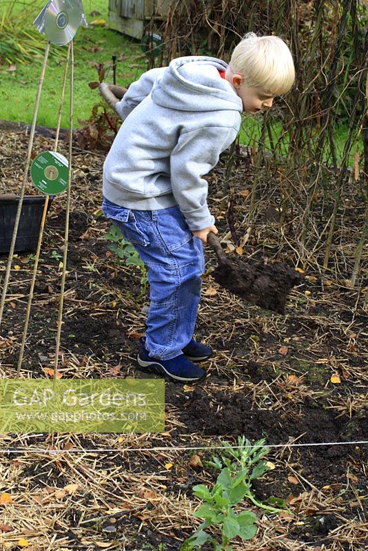Leonie Woolhouse's grandson, Arthur, learning how to dig in the vegetable garden - The Old Sun House, Wymondham, Norfolk, NGS 