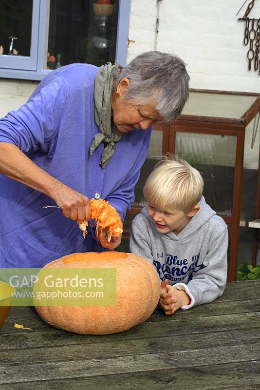 Leonie Woolhouse carving a pumpkin for Halloween with her grandson, Arthur - The Old Sun House, Wymondham, Norfolk, NGS