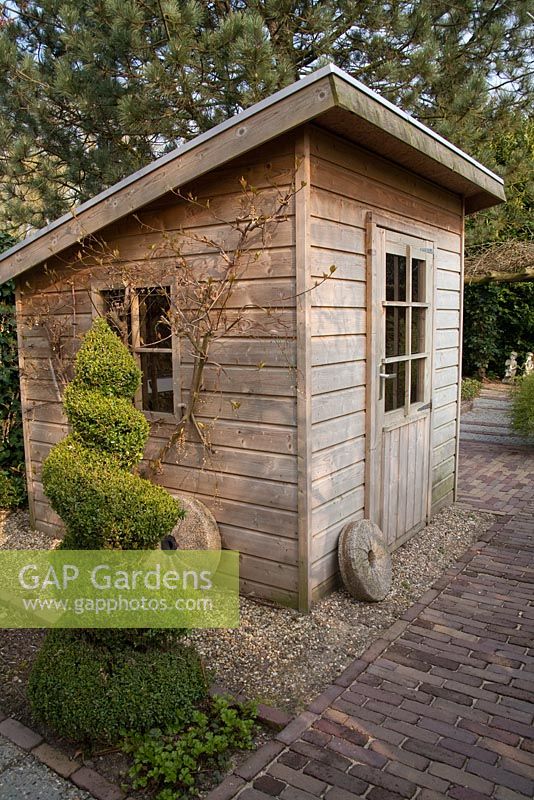 Wooden shed and spiral topiary - Appeltern garden, Holland 