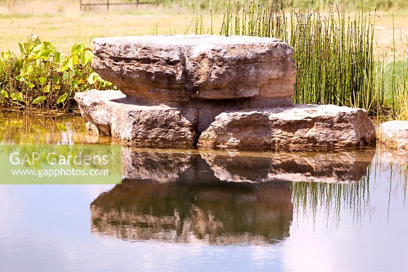 Rocks used as a diving platform in a natural swimming pool
