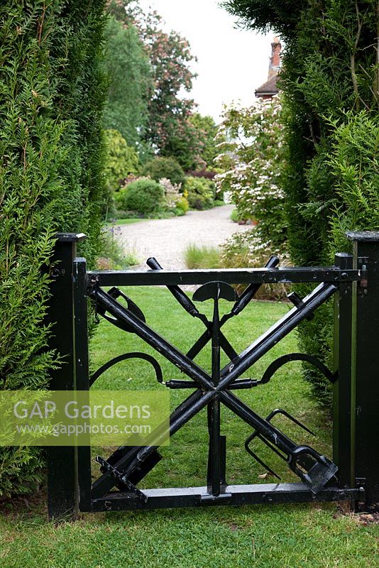 Metal garden gate made from old gardneing tools