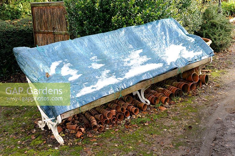 Garden furniture winter protection - Garden seat covered with taurpaulin, with terracotta pots underneath, November