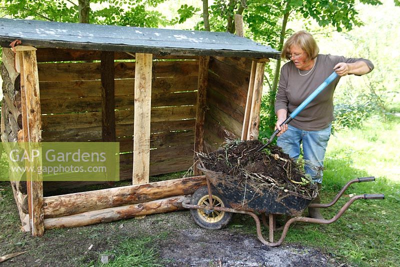 Filling a compost bin - Start with a layer of old, partially rotted material