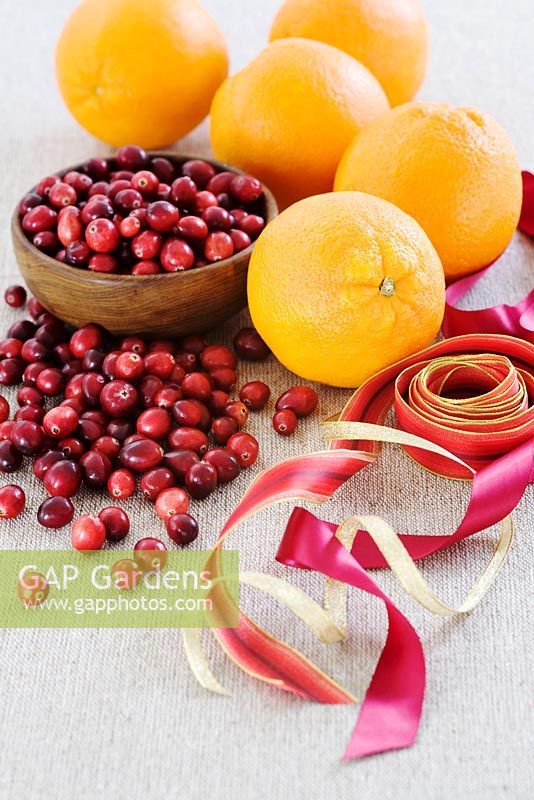 Making a Cranberry and Orange pomander for Christmas - cranberries, oranges and ribbons