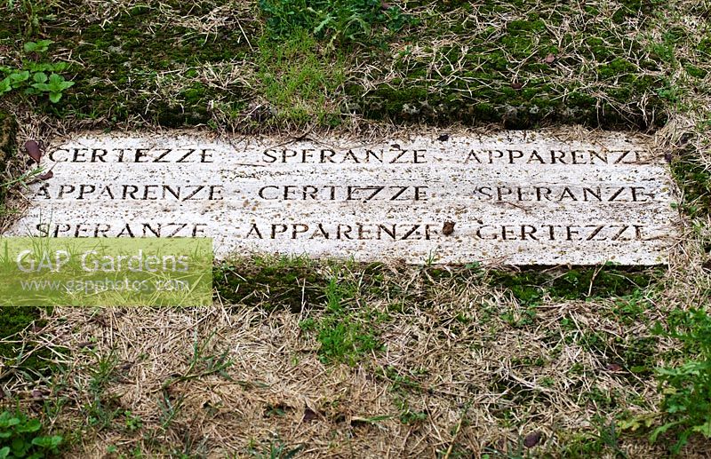 Inscription on slab in lawn. The Field. Il Bosco Della Ragnaia, San Giovanni D'Asso, Tuscany, Italy, October. 
 