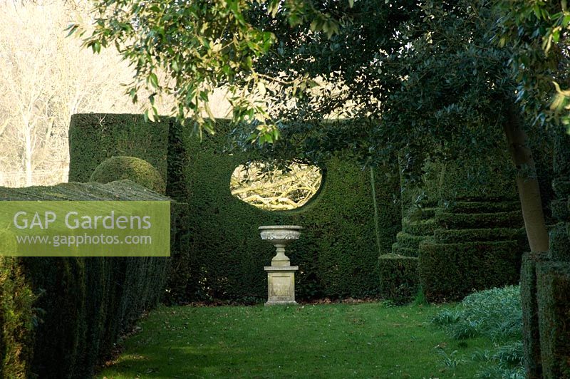 Shaped evergreen hedge with 'window' in it. Mr and Mrs E Barham, Hole Park, Rolvenden, Kent, UK