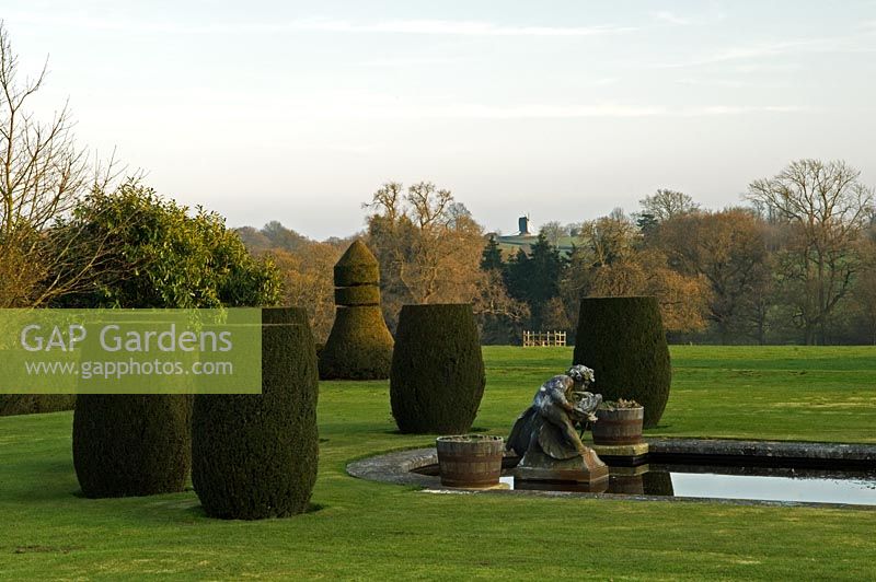 Formal garden with topiary on lawn. Mr and Mrs E Barham, Hole Park, Rolvenden, Kent, UK