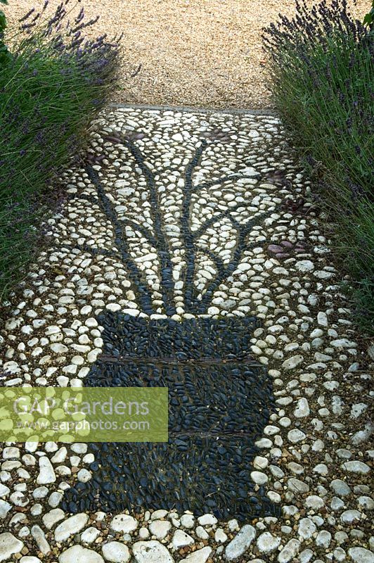 Detail of mosaic pattern in path edged with Lavandula - Lavender. Parsons Cottage, Essex, UK
