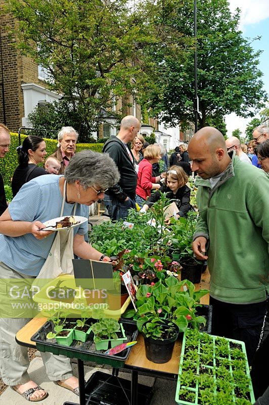 People buying plants from stall in street, Hackney, London