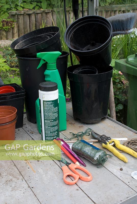 Greenhouse staging with pots, string, scissors, secateurs and chemicals