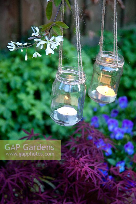 Tealights in jars hanging above border
