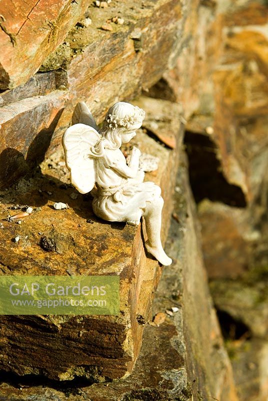 Fairy figurine on granite wall - Pinsla Garden, Cardinham, Cornwall