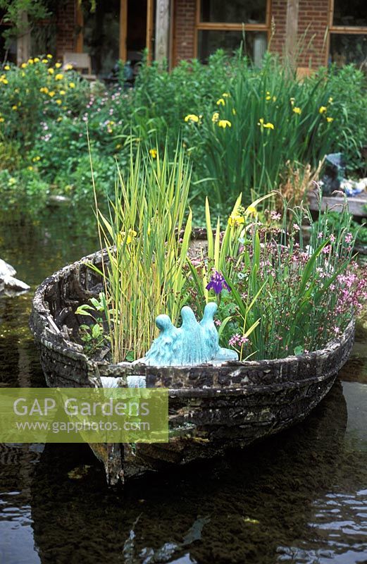 Old boat used as a planter - Natural Water Garden, Nine Spring's House