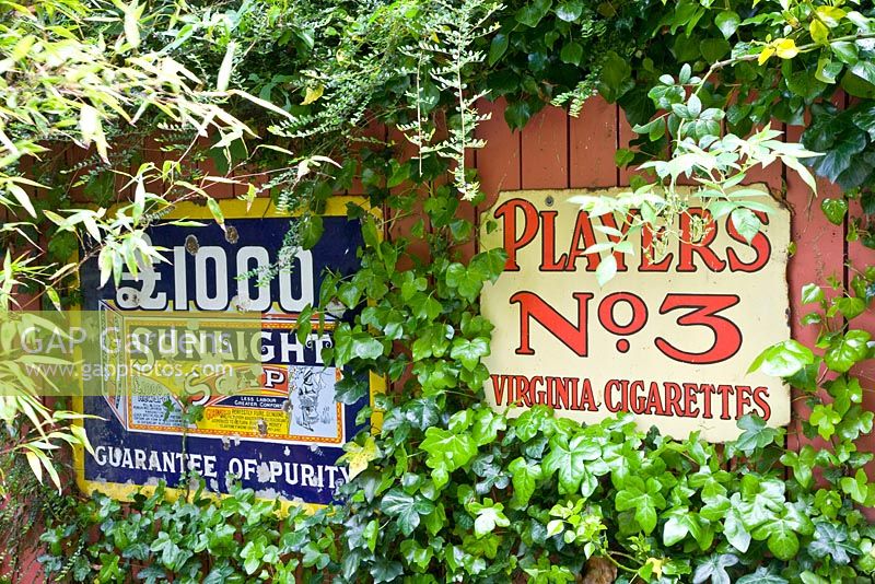 Old enamel signs - Helen Riches' Garden, Essex 
