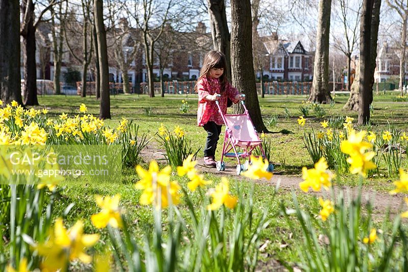 Young girl playing in Spring garden