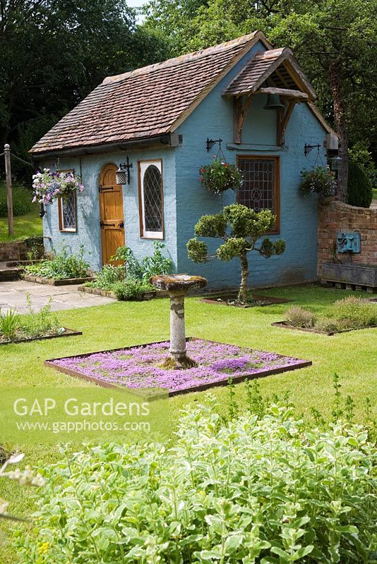 Garden cottage room painted blue with stained glass windows