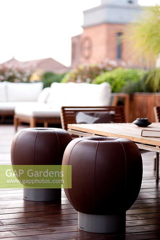 Terrace in Ferrara with seating area and leather stools