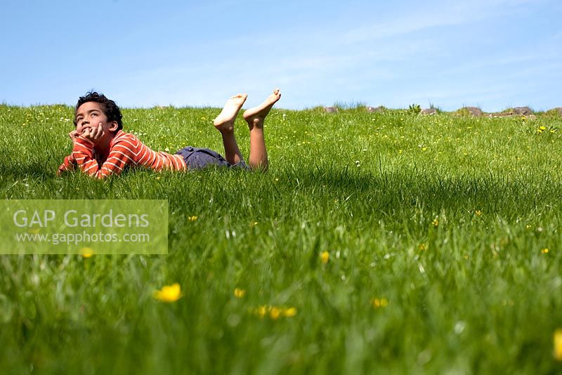 Boy lying in the grass 