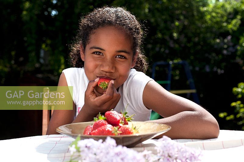 Girl eating freshly picked strawberries