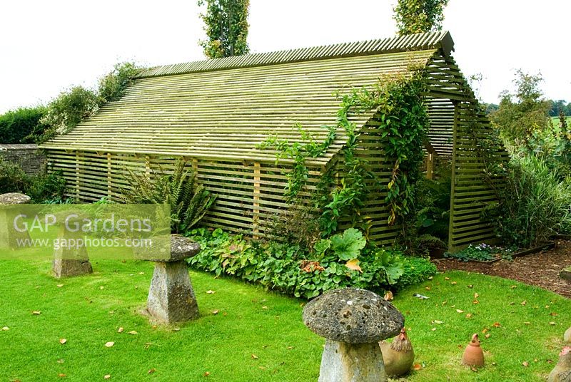 Shadehouse with chickens by Ann James nearby. Bourton House, Bourton-on-the-Hill, Moreton-in-Marsh, Glos, UK
