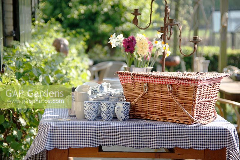 Table with crockery and picnic hamper at Bed and breakfast de Lievendael in Velp, Brabant, Holland