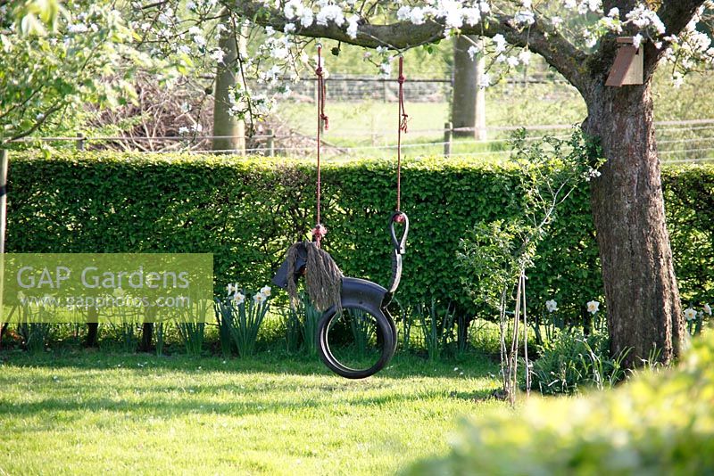 Horse swing made from recycled tyres in Spring garden at Bed and breakfast in Velp, Brabant,  Holland