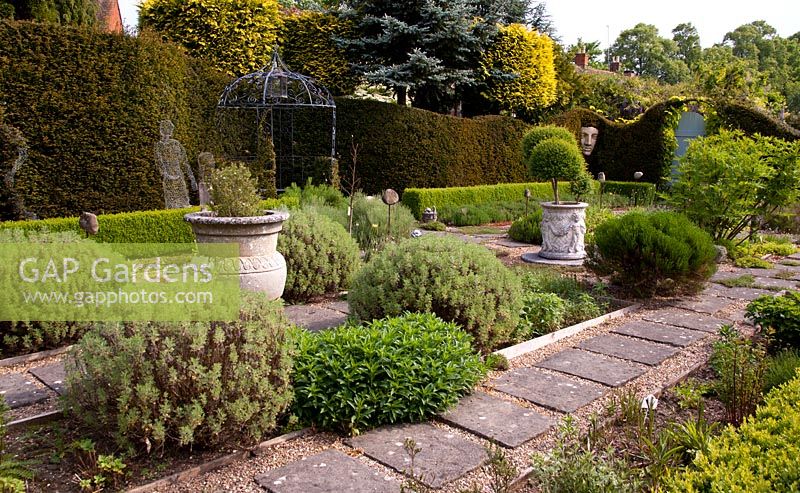 The herb garden, with Yew hedge, topiary, Face sculpture and formal planting - Tilford Cottage, Surrey