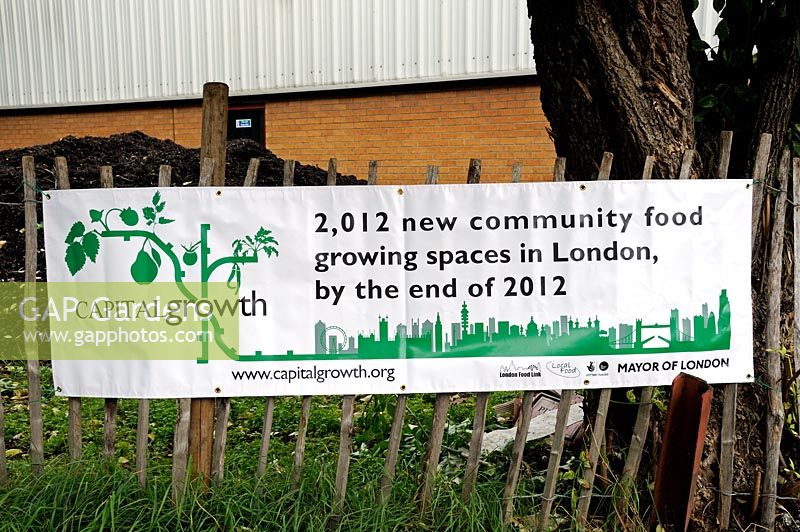 A Capital Growth banner on fence advertising 2012 new community food growing spaces in London by the end of 2012