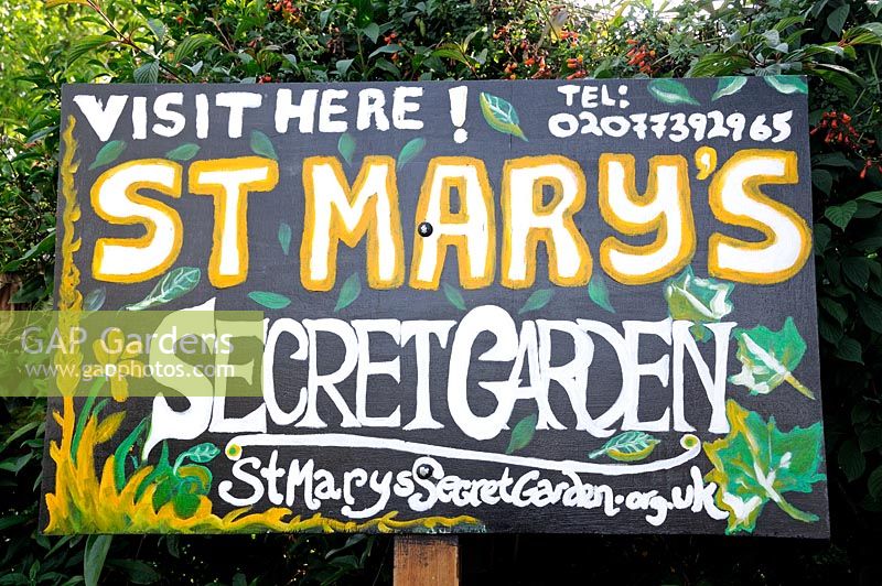 Hand painted sign for St. Mary's Secret Garden, a community garden in Hackney London UK