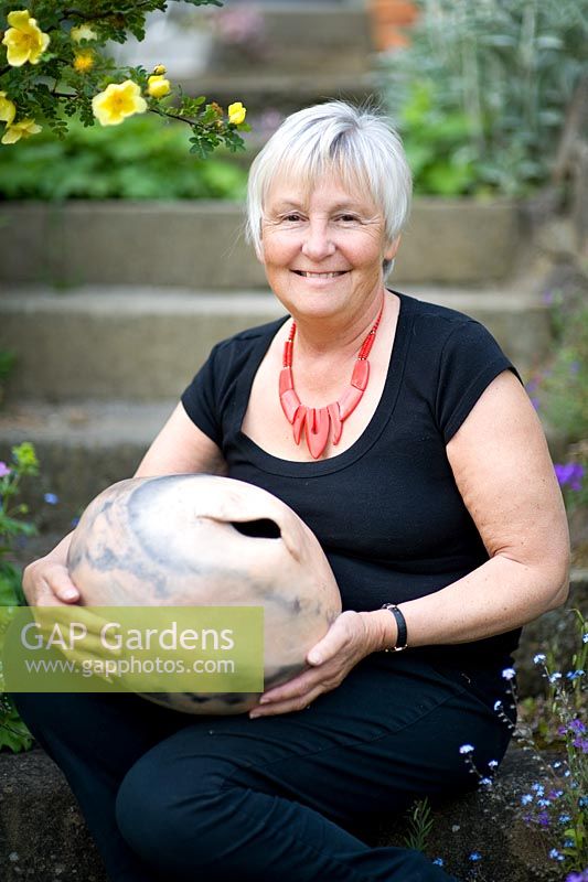 Cherry tree garden owner, June Skinner holds one of her recent ceramic pieces