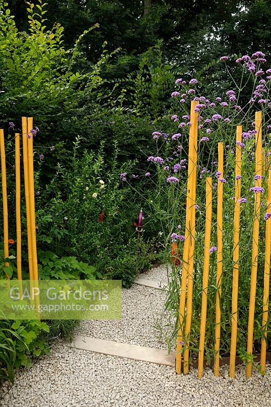 Yellow painted bamboo canes used as path edging - Festival International des Jardins de Chaumont sur Loire 2010