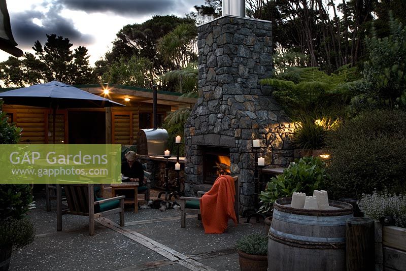 Exterior fireplace and entertaining area. Laurus - Bay trees and Cyathea dealbata - Tree Ferns. New Zealand