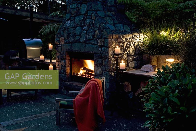 Exterior fireplace and entertaining area. Laurus - Bay trees and Cyathea dealbata - Tree Ferns. New Zealand 
